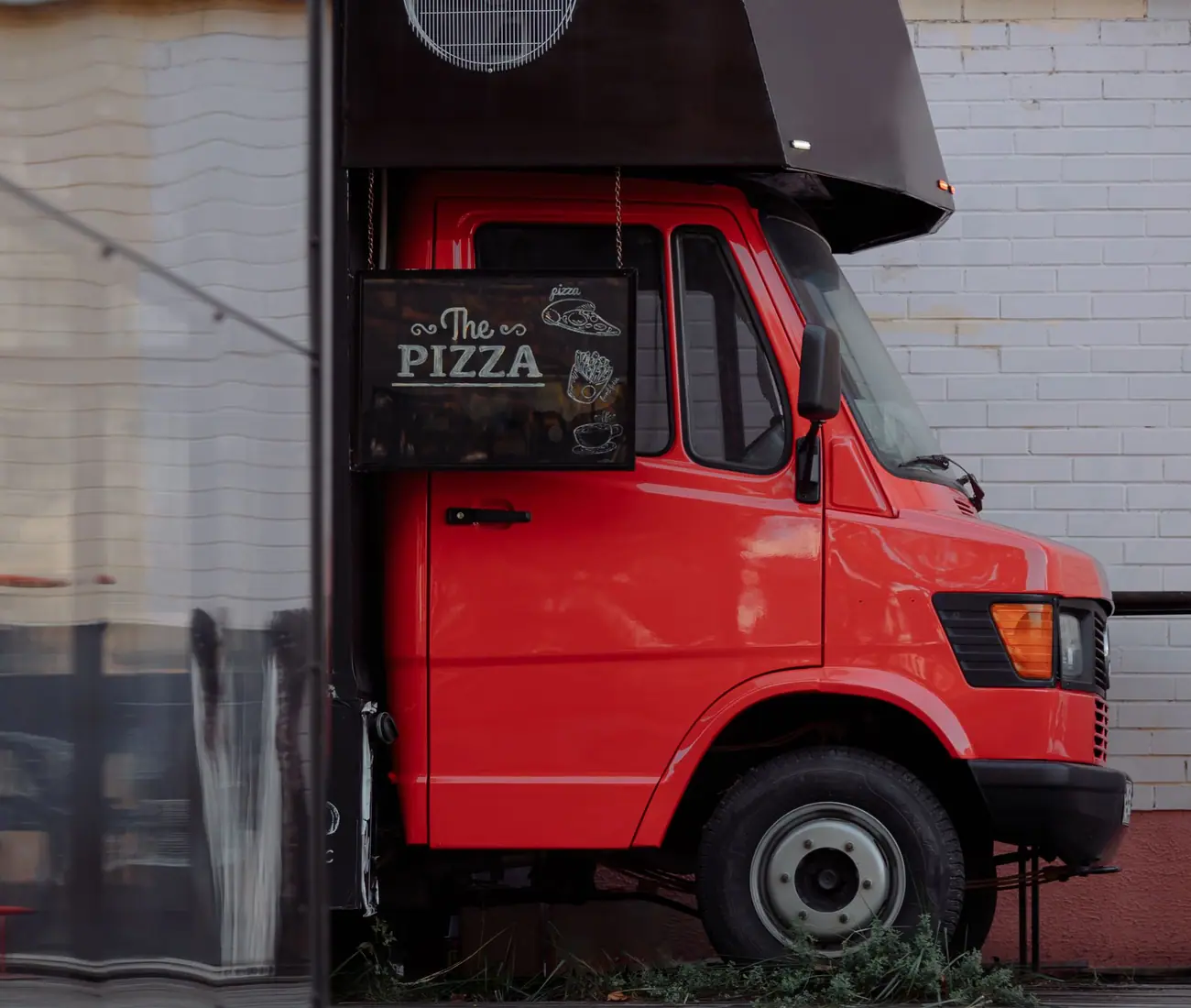 The service side of a food truck, hatch propped open
