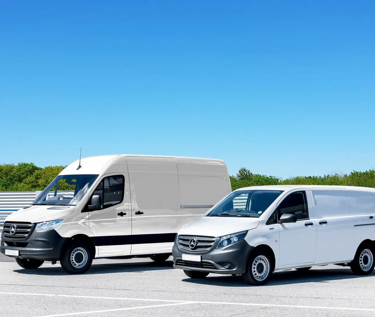 Two unmarked white vans parked side by side