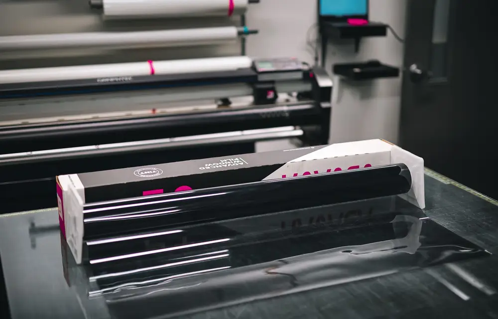 Close-up of laminating rollers feeding printed material through under pressure